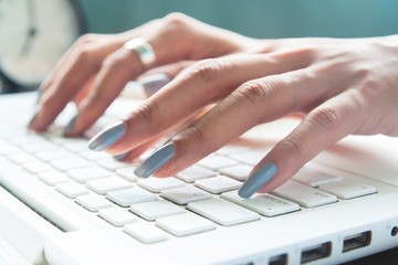 Close up of female fingers using laptop, Working woman and Online shopping concept, Selective focus