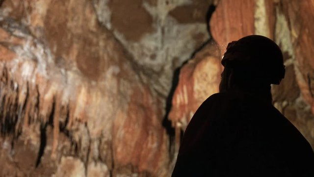 Man with headlamp inside cave