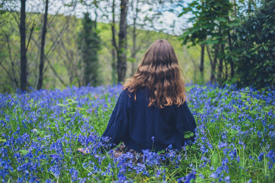 Young woman in meadow of bluebells