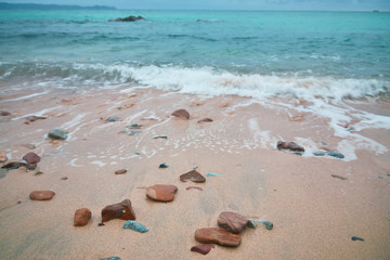Soft wave of blue ocean on sandy beach. Background.