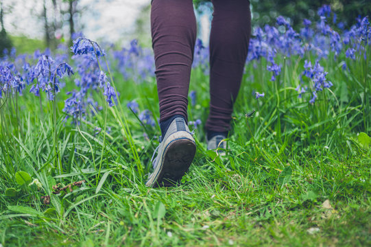 Feet of woman walking in meadow