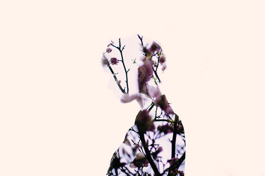 Double exposure of woman and flowers