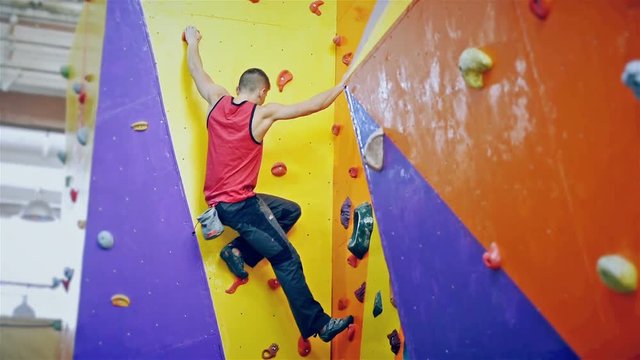 Free Climber Man Climbing On Practice Wall Indoors