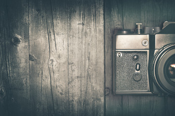 Old camera on wooden background