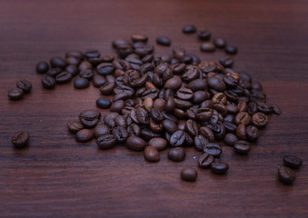 Black coffee beans on a brown tree