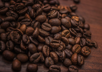 Black coffee beans on a brown tree