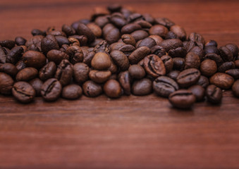 Black coffee beans on a brown tree