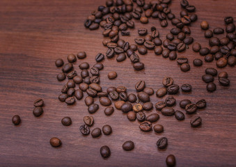 Black coffee beans on a brown tree
