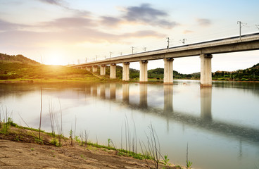 A high-speed train running on an elevated bridge