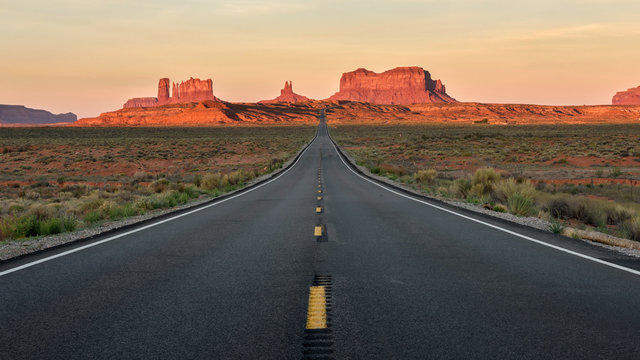 Straight Road vanishing into Monument Valley