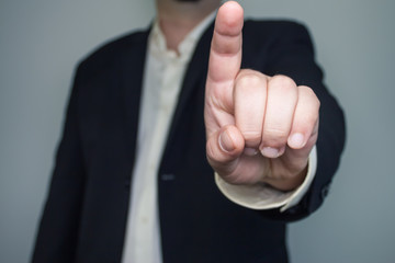 Man in suit with one finger up