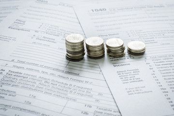 Coins on top of multiple 1040 USA tax forms