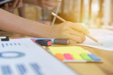 Naklejka premium startup young successful team on meeting in modern office interior brainstorming, make a business plan, working on financial and marketing graph and chart