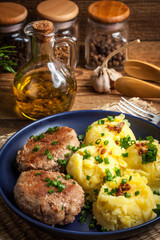 Meatballs served with boiled potatoes on a plate.