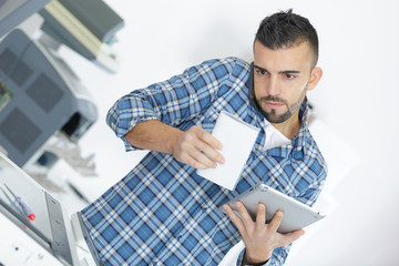 Repairman holding phone between chin and shoulder