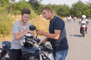 Fototapeta na wymiar motorbike teacher showing student how to pass