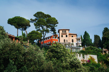 Fototapeta premium Typical italian villa among green trees in summer. Scenic landscape view travel picturesque postcard.