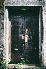 Grunge rusty old aged metal door with locker closeup.
