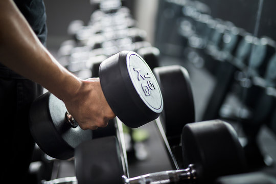 Man use weight training in Fitness center