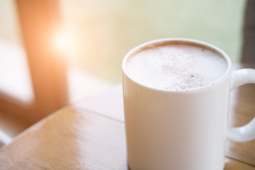 Cup of cappuccino coffee, hot mocha drink with cream and cinnamon