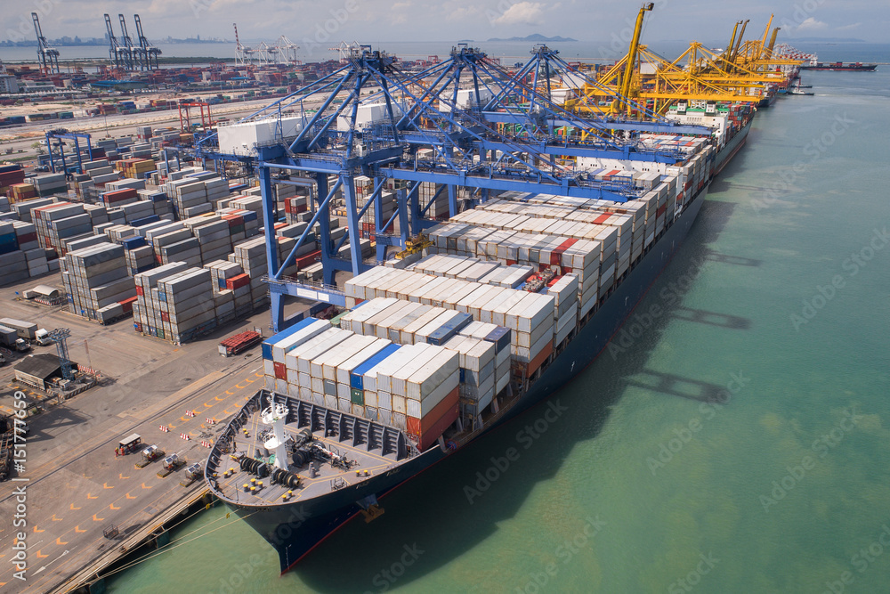 Fototapete container box loading by crane, vessel boat in logistic port