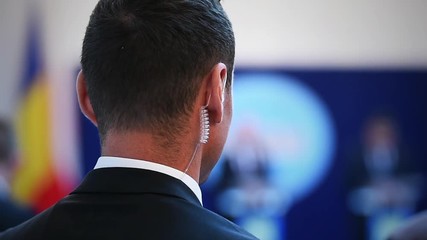 Detail with a bodyguard wearing in ear headset