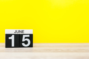 June 15th. Day 15 of month, calendar on yellow background. Summer day. Empty space for text. Global...