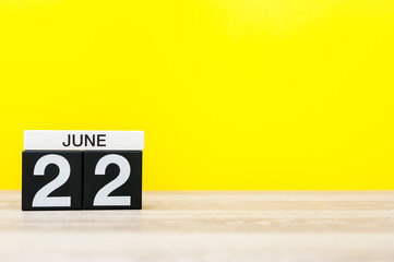 June 22nd. Day 22 of month, calendar on yellow background. Summer day. Empty space for text