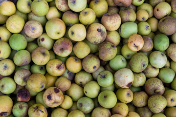 Green apples on the organic traditional food market of tropical Bali island, Indonesia. Sukawati market. Apples background.