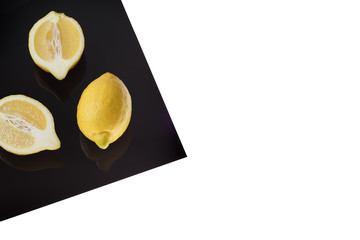 Lemon on Black Sheet Isolated on white