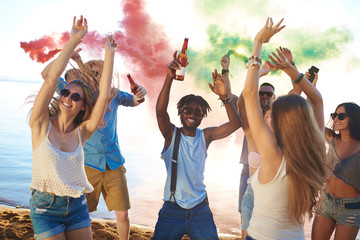 Ecstatic friends dancing energetically on the beach