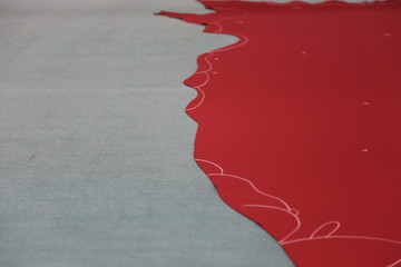 red leather with chalk lines on gray surface