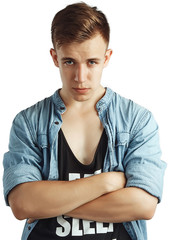 Portrait of a smart serious young man standing against blue background