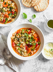 Vegetarian minestrone - delicious healthy mediterranean lunch. On a light table, flat lay