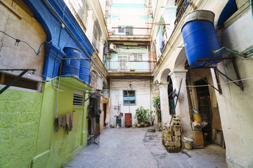 Fototapeta na wymiar View to a internal courtyard of old dilapidated poor house in the slums at Havana
