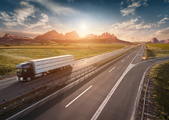 Single delivery truck on highway at idyllic morning