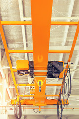Overhead crane or bridge crane consists of parallel runways with a bridge between column also...