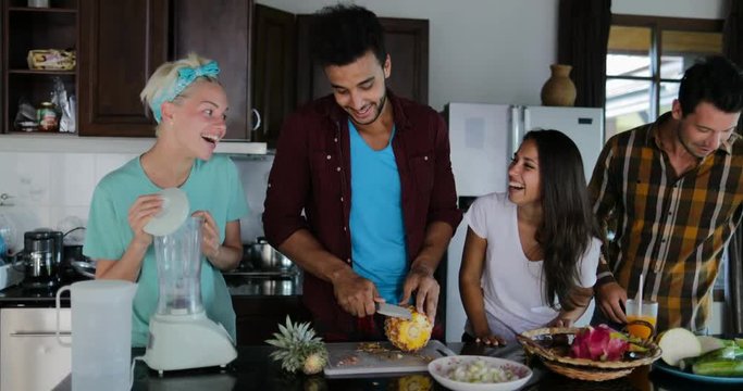 Two Couples In Kitchen Cooking Together, Young Woman And Man Group Talking Cut Vegetables And Fruits Prepare Healthy Meal Slow Motion 60