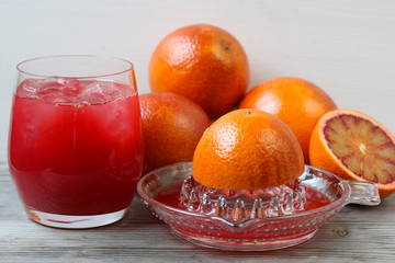 Red orange juice. Grey wooden background. Top view.