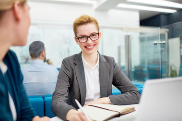 Female business leader looking at camera in office