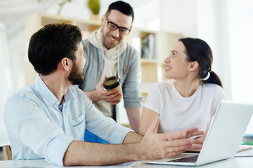 Group of happy managers having discussion of project
