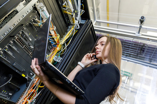 Young woman engineer at the network equipment