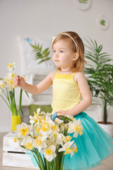 Obraz na płótnie Canvas happy toddler girl with flowers