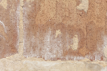 A wall of rough red bricks with some cement. Backdrop texture.
