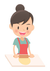 料理をする主婦　生地を伸ばす