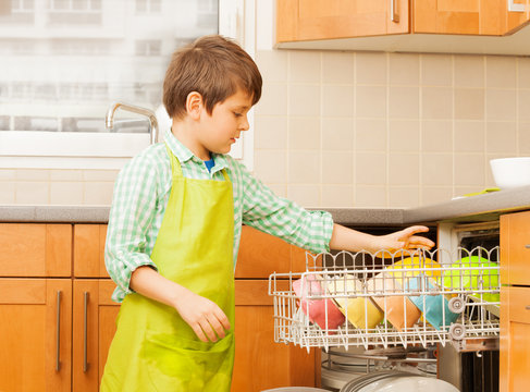 Kid Boy Getting Out Clean Crockery Of Dishwasher