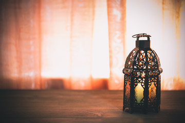 The Muslim feast of the holy month of Ramadan Kareem. Beautiful background with a shining lantern...