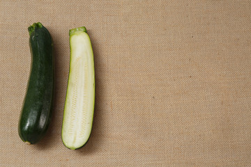 Fresh Zucchini lying on a sackcloth surface
