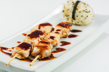 Yakitori Japanese chicken barbecue served with rice on a white background