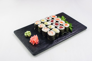 Sushi Set and sushi rolls served on white background